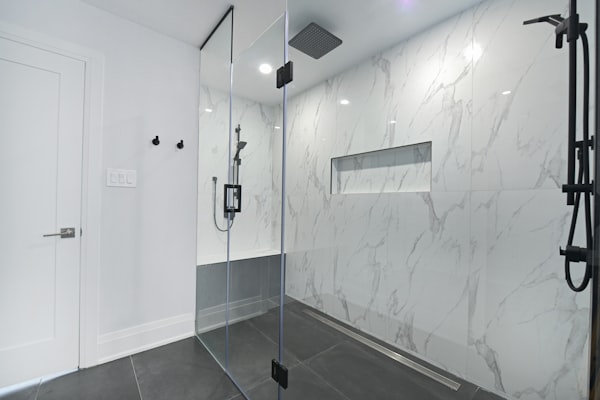 Modern walk-in shower with professional plumbing installation