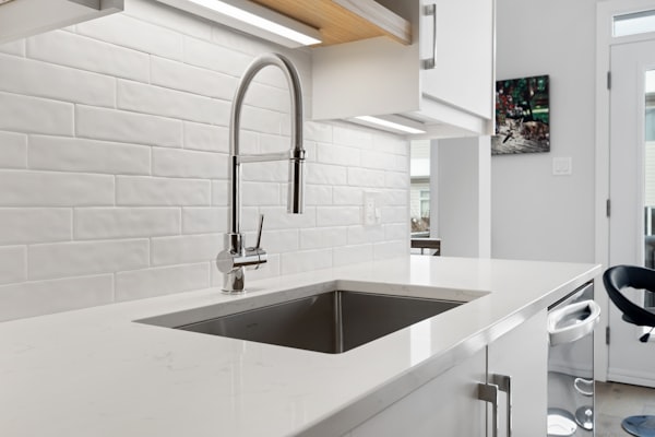 Beautiful kitchen with modern plumbing fixtures by a window