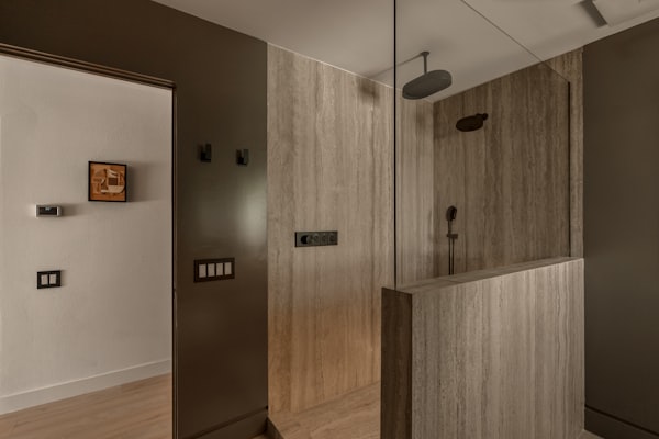 Modern glass shower enclosure with plumbing fixtures